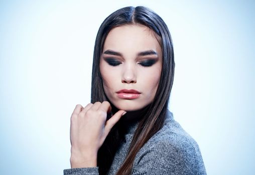 Beautiful makeup eyeshadows on the eyelids And pink lips of a brunette woman on a light background. High quality photo