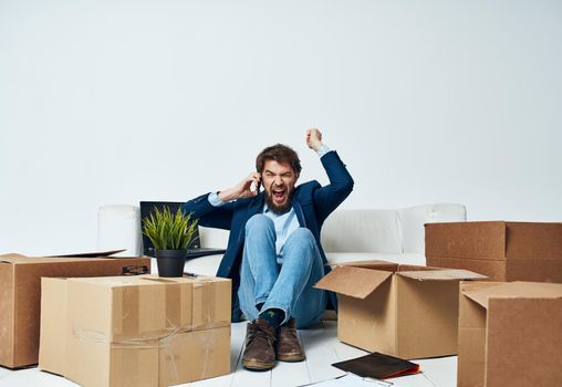 Man in a suit boxes with things moving office professional unpacking. High quality photo