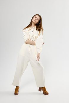 pretty woman in white jumpsuit studio fashion lifestyle model. High quality photo