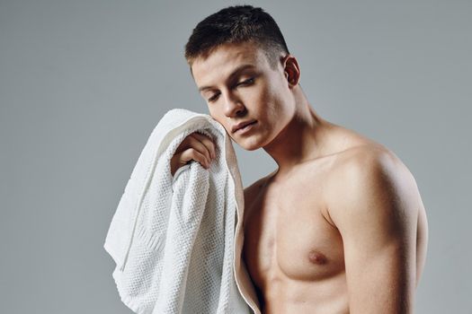 portrait of sporty man with towel in hands cropped view of bodybuilder workout. High quality photo