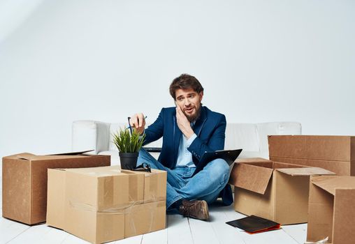 A man in a suit boxes with things communicating on the phone office official unpacking. High quality photo