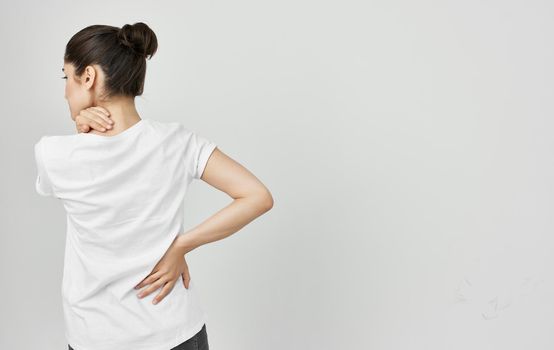 woman in white t-shirt health problems body pain discomfort. High quality photo