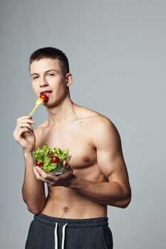 mouse male with bare shoulders and plate of salad healthy food cropped view. High quality photo