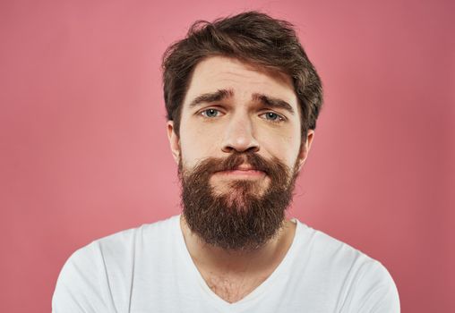 Male cropped view portrait of brunet bushy beard white t-shirt. High quality photo