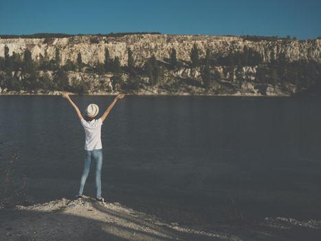 Energetic woman traveler near the river on nature in the mountains. High quality photo