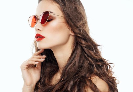 Portrait of attractive woman wearing glasses curly hair brunette light background. High quality photo