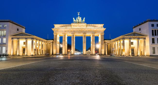 Panorama of the illuminated Brandenburg Gate in Berlin at night