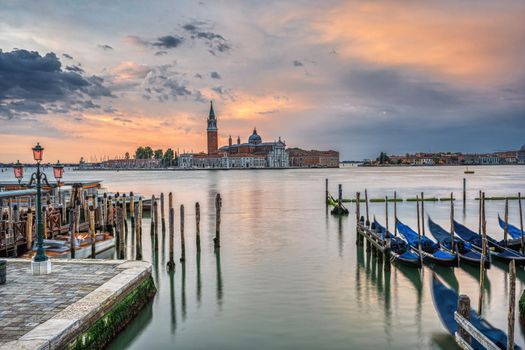 Dramatic sunrise in Venice, Italy, with some of the traditional gondolas