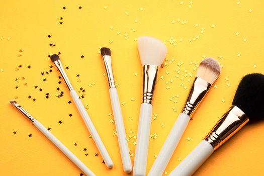 Womens makeup cosmetics decoration collection yellow background. High quality photo