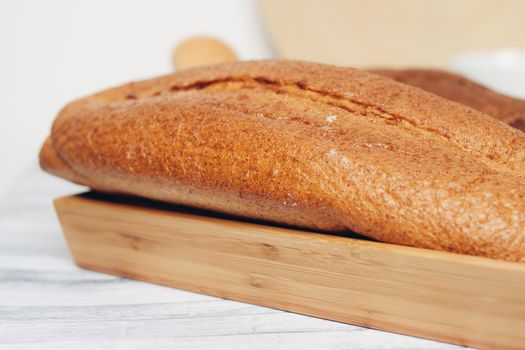 fresh loaf bread bins on the table kitchen food ration . High quality photo