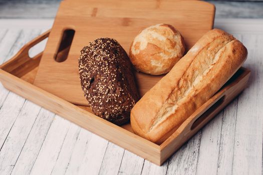 whole grain bread loaves homemade cakes cooking wood board close-up. High quality photo