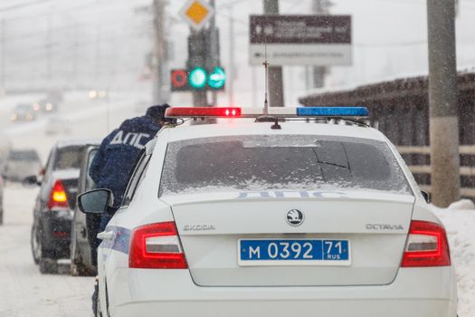 Tula, Russia - February 13, 2020: Russian police car at winter snowfall at day light close-up, abbreviation DPS means Road Patrol Service