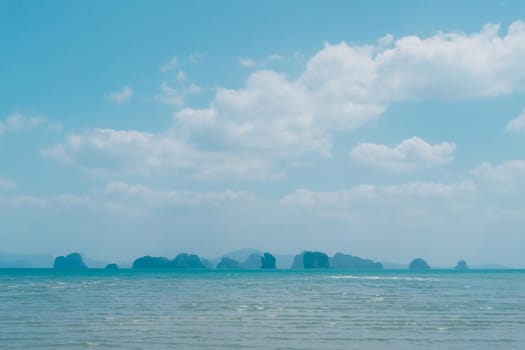 Tropical nature clean beach and white sand in summer season with sun light blue sky background.