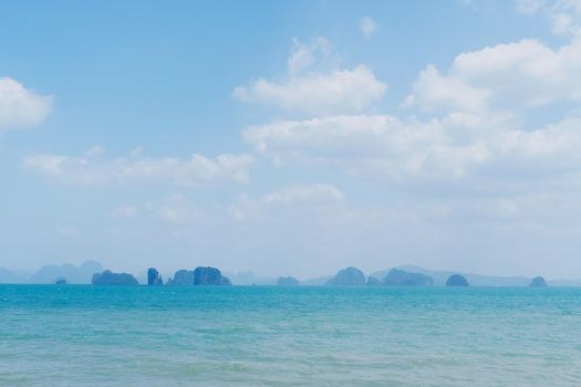 Tropical nature clean beach and white sand in summer season with sun light blue sky background.