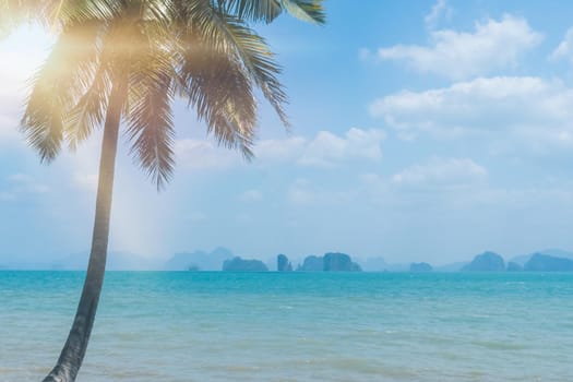 Tropical nature clean beach and white sand in summer season with sun light blue sky background.