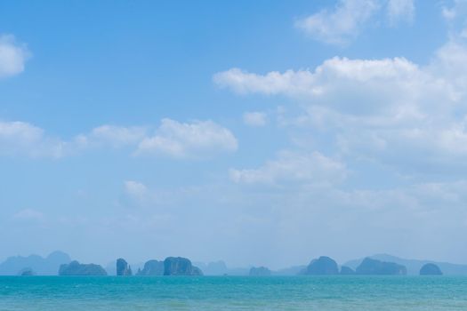 Tropical nature clean beach and white sand in summer season with sun light blue sky background.