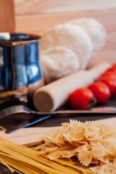 pasta sprinkled on the table tomatoes through italian cuisine. High quality photo