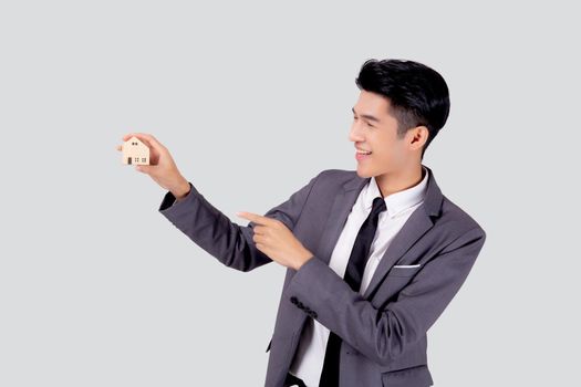 Young asian business man holding the home symbol of saving for future, insurance agent and credit, ownership house, debt and loan of finance, purchase home and refinance, investment real property.