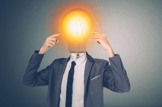 Portrait businessman in suit with light bulb on head, inspiration and innovation for success, thinking and idea of creative, intelligence and vision, brain and solution, business concept.