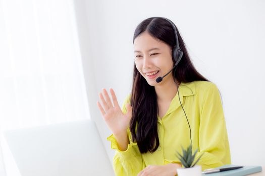 Young asian business woman using laptop computer for video conference online with social distancing, businesswoman working with video call, new normal, communication and work from home concept.