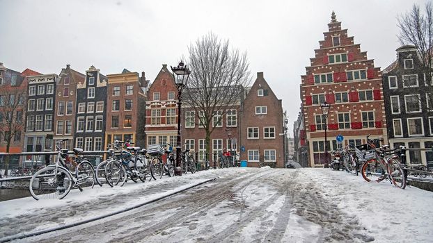 Snowy city Amsterdam in winter in the Netherlands