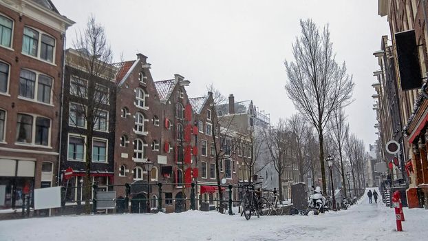 Snowy city Amsterdam in the red light disrict in the Netherlands in winter