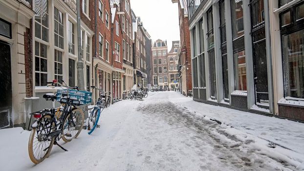Snowy city Amsterdam in the Netherlands with the St. Nicolas church in winter