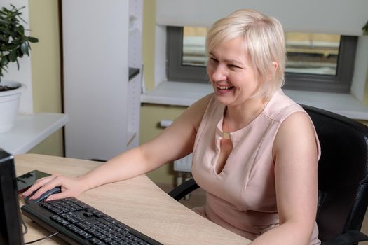 A female director working in an office is sitting at a table, analyzing business statistics, checking documents. Close-up.