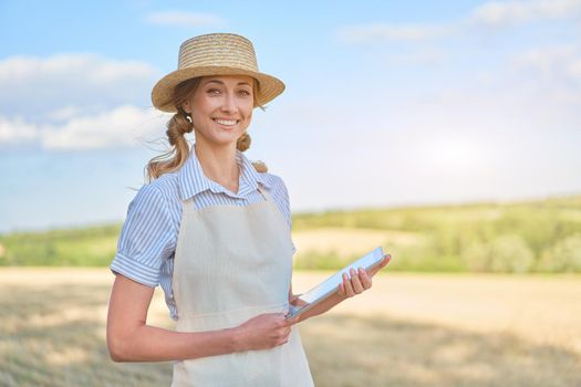 Woman farmer straw hat smart farming standing farmland smiling using digital tablet Female agronomist specialist research monitoring analysis data agribusiness Caucasian worker agricultural field
