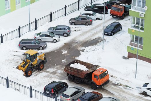 Nizhny Novgorod, Russia, Gagarin Avenue 101 Corps 1. 2021.03.03. Snowplows in the city. Cleaning yards and streets from snow special equipment. High quality photo