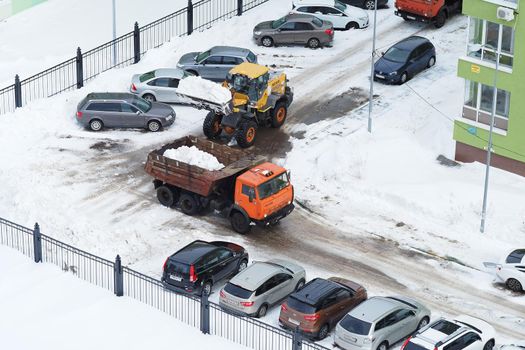 Nizhny Novgorod, Russia, Gagarin Avenue 101 Corps 1. 2021.03.03. Snowplows in the city. Cleaning yards and streets from snow special equipment. High quality photo