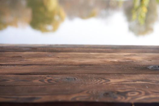 Empty wooden table nature bokeh background with a country outdoor theme,Template mock up for display of product Copy space Lake