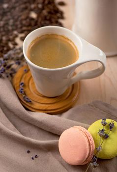 cup of coffee and coffee beans in a sack on dark background