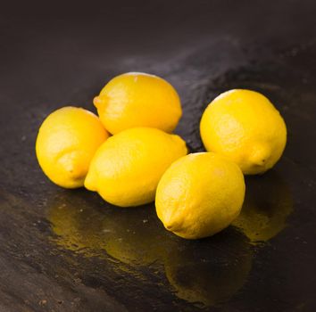 Tasty lemons isolated on the black background