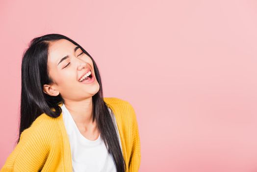 Happy Asian portrait beautiful cute young woman standing winning and surprised excited screaming laughing look face up, studio shot isolated pink background, Thai female smiley funny with copy space