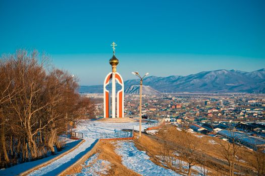 Urban landscape with views of the chapel on the background of the city. Nakhodka, Russia