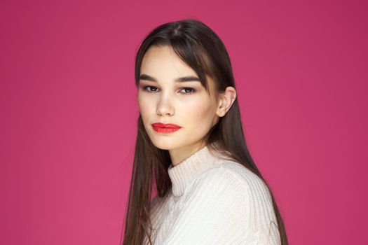 Woman with long hair and red lips white blouse pink background attractive look. High quality photo