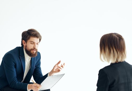 A man in a classic suit is talking to a female psychologist communication work office. High quality photo