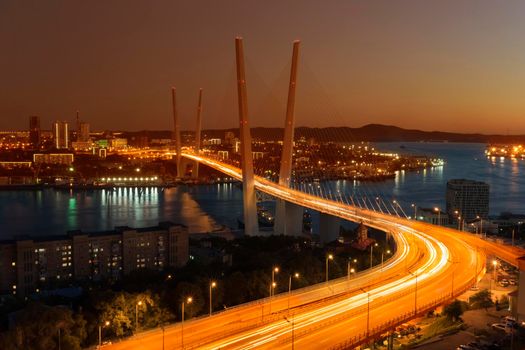 Sunset over Vladivostok and view of the Golden bridge, Russia.