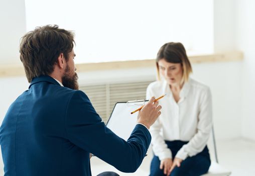 A man next to a woman communication discussion professional consultation mental problems. High quality photo