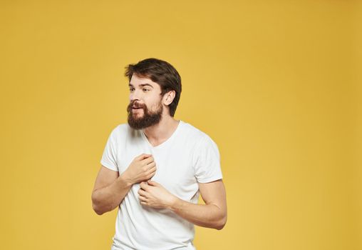 male model gesturing with his hands on a yellow background cropped view Copy Spac. High quality photo