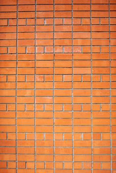 A new, smooth red brick wall. The bricks are laid in rows. Grunge stone texture. There is a place for the text