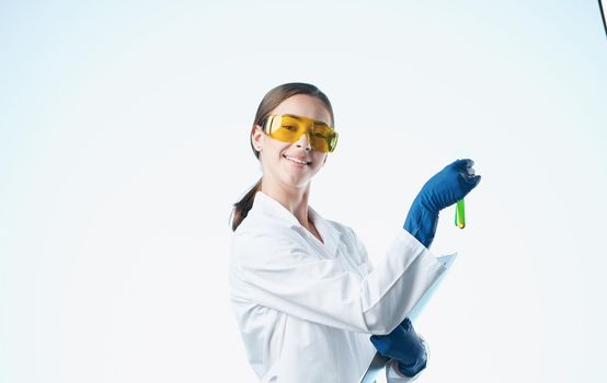 woman doctor in medical gloves and in a white medical coat holds flasks in her hands documents. High quality photo