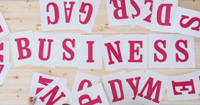 Making business concept, word made of red letters on white paper, table top view