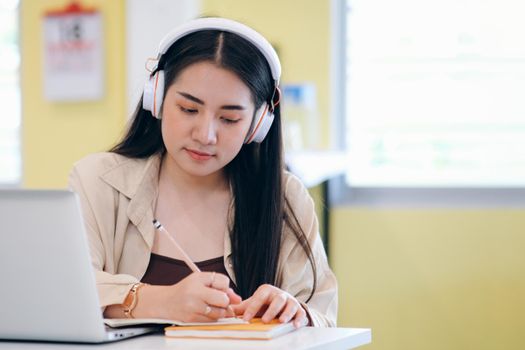 Young collage student using computer and mobile device studying online. Education and online learning. 