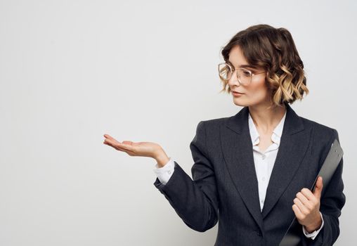 Woman in classic suit shows business financial documents and Copy Space with her hand. High quality photo