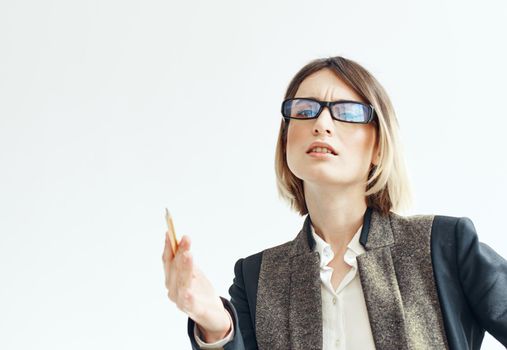 Business woman gestures with her hands on a light background suit finance. High quality photo