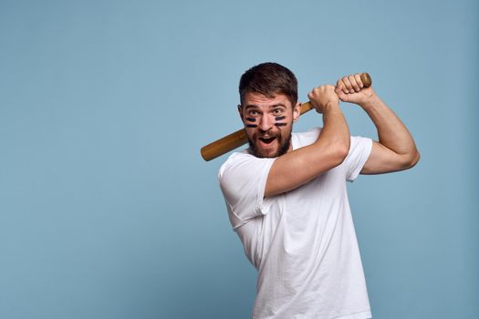 Man in white t-shirt baseball bat sport blue background. High quality photo