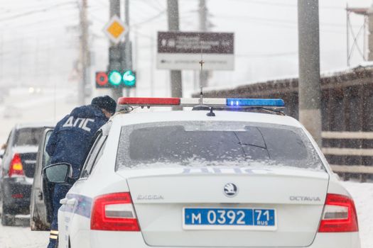 Tula, Russia - February 13, 2020: Russian police car at winter snowfall at day light close-up, abbreviation DPS means Road Patrol Service