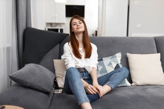 pretty woman sitting in comfortable sofa and resting interior. High quality photo